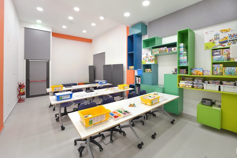 Yellow LEGO Education storage boxes on a table